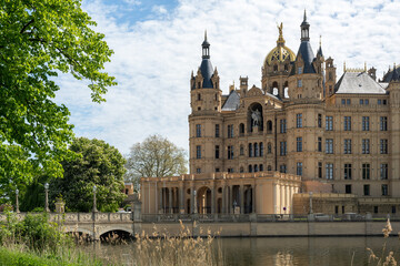 Fototapeta na wymiar Portal and entrance of the Schwerin Castle or Schwerin palace, in German Schweriner Schloss, a romantic landmark building on a lake in the capital city of Mecklenburg