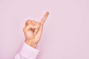 Hand of caucasian young man showing fingers over isolated pink background showing little finger as...