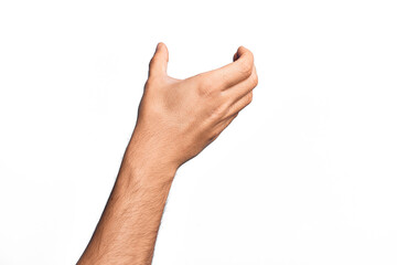 Hand of caucasian young man showing fingers over isolated white background holding invisible object, empty hand doing clipping and grabbing gesture - obrazy, fototapety, plakaty