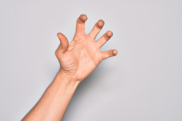 Hand of caucasian young man showing fingers over isolated white background grasping aggressive and...