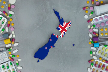 The New Zealand State began research for treatment and medicine to combat the pandemic outbreak disease coronavirus. Medicine, pills, needles, syringes and New Zealand map and flag on background.