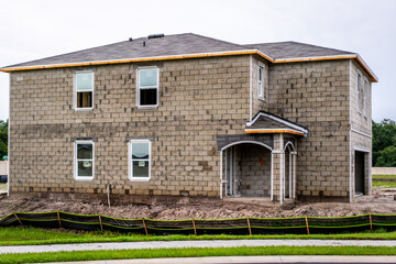 Fototapeta premium New home construction in west-central Florida from foundations, blockwork, framing, electrical, plumbing, HVAC, and setting trusses.