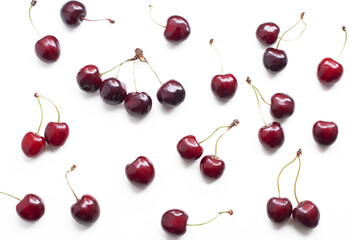 Ripe sweet cherries on a white background. Pattern with ripe sweet cherries