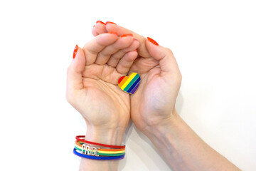 Female hands hold a rainbow heart. LGBT concept. Free love