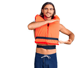 Young handsome man wearing nautical lifejacket gesturing with hands showing big and large size...