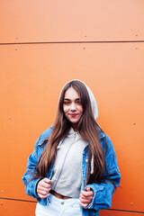 young pretty teenage girl posing cheerful happy smiling wearing street style outside in europe city, lifestyle people concept