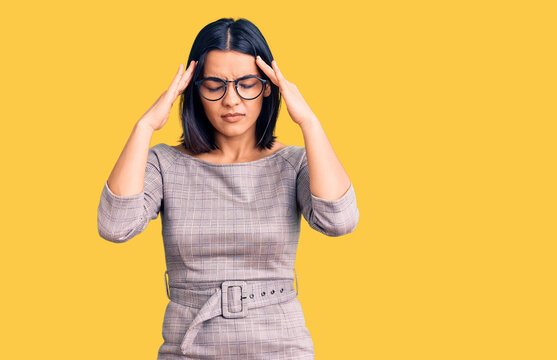 Young beautiful latin woman wearing casual clothes suffering from headache desperate and stressed because pain and migraine. hands on head.
