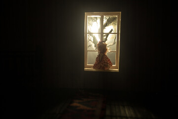 Old creepy eerie baby crib near window in dark room. Scary baby silhouette in dark. A realistic...