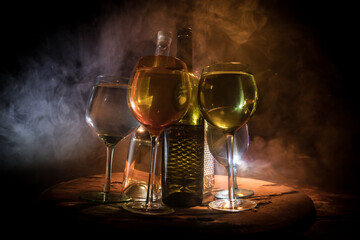 Goblet of white wine on wooden table on wooden wall background
