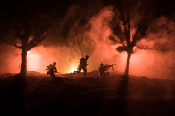 Fototapeta premium War Concept. Military silhouettes fighting scene on war fog sky background, World War Soldiers Silhouette Below Cloudy Skyline At night.
