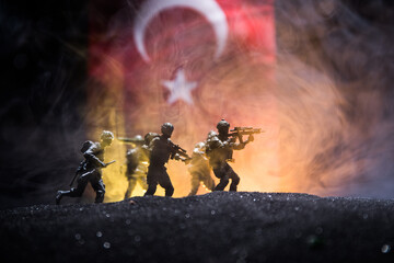 Silhouette of soldier with rifle against a turkish flag. Selective focus - obrazy, fototapety, plakaty