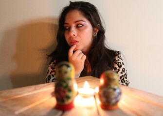 Gypsy girl with matruskas  and candles 
