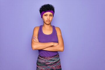 Beautiful african american afro woman wearing casual sportswear over purple background skeptic and...