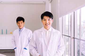 Fototapeta premium Asian men scientist smiling face and working in hospital,Professional medical teamwork