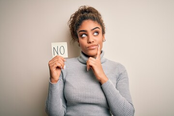 Young african american girl holding reminder paper with no word negative message serious face...