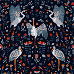 White storks with ornaments on a blue floral background. Folk Art. 