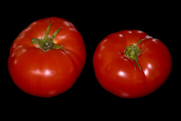 Red tomatoes on black background