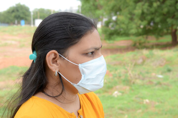 asian lady wearing medical mask  for protection from viruses and bacterias durind covid 19 pandemic