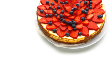 cheesecake with strawberries and blueberries, isolated on white background with copy-space