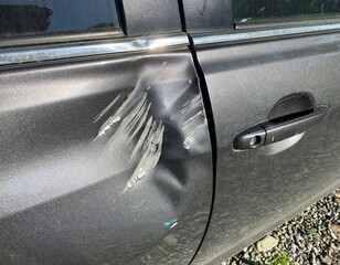 The dents on the car door caused by the accident