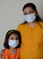 a mother and her daughter with wearing mask for protection of corona virus during covid 19 pandemic