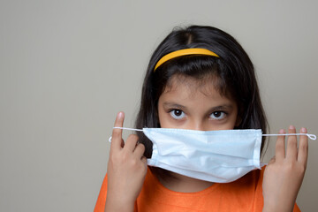 asian kid with wearing  mask due to covid 19 pandemic