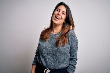 Young beautiful brunette woman smiling happy and confident. Standing with smile on face wearing casual sweater over isolated white background