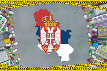 Serbia is struggling with an epidemic coronavirus pandemic. Serbia quarantine measures and coronavirus. Medicine, drugs, needles, syringes and Serbia map and flag over gray background.