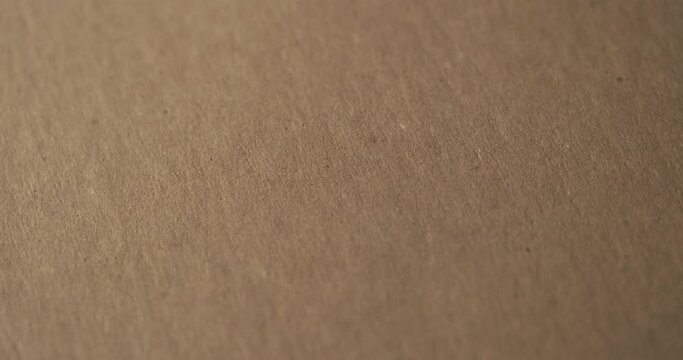 4K brown cardboard paper rotating in macro focus