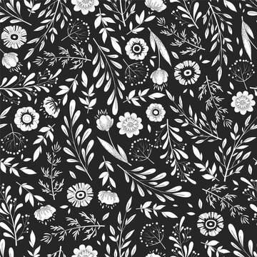 Seamless vector doodle pattern with hand drawn flowers, herbs, leaves and branches on black background. Monochrome floral design template for print, fabric, invitation, brochure, card, wallpaper