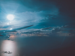 Sunrise above clouds from window of an aircraft