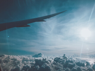 Naklejka premium Sunrise above clouds from window of an aircraft
