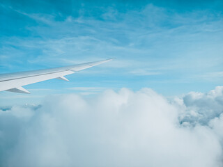 Sunrise above clouds from window of an aircraft