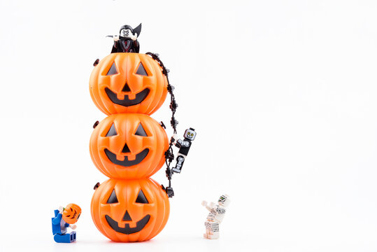 Nonthabure, Thailand - August, 09, 2017: Lego ghost moster climbing on the pumpkinhead used for decorations on halloween day.Theme Halloween background.