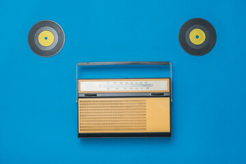 Retro radio with two vinyl discs on a blue background. Radio engineering of the past time.