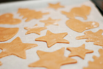Star-shaped gingerbread cookie with on parchment. Christmas dessert. The process of baking cookies....
