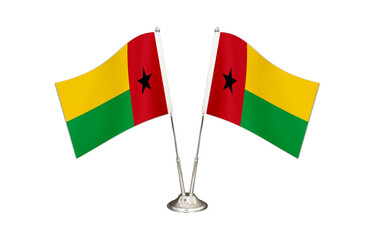 Guinea Bissau table flag isolated on white ground. Two flag poles with flags and Guinea Bissau flag on the table.