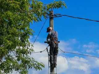 Electrician repairing,electricians repairing wire on electric power pole