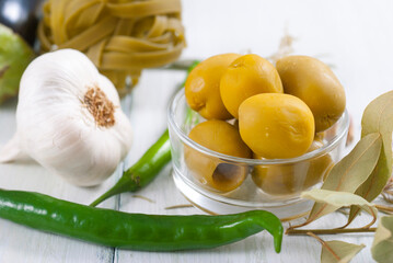 traditional italian food ingredients on white wood table