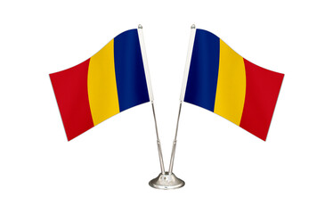 Romania table flag isolated on white ground. Two flag poles with flags and Romania flag on the table.