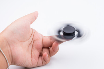 Nonthaburi, Thailand - June, 16, 2017 : Women hand holding popular fidget spinner toy.