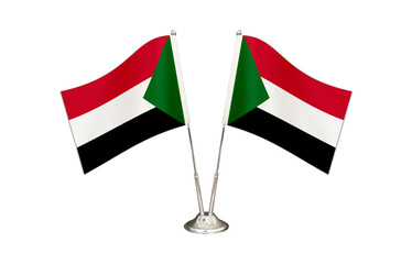 Sudan table flag isolated on white ground. Two flag poles with flags and Sudan flag on the table.