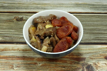 Traditional sticky rice dumpling in the bowl with grilled pork, ginkgo, roasted pork sausage, pepper, and local ingredients in Asia. Famous ancient food in Chinese ceremony. 