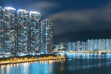 High rise residential building and harbor in Hong Kong city at night
