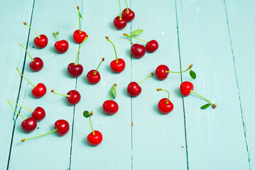 sour cherry fruits on old blue wooden table background