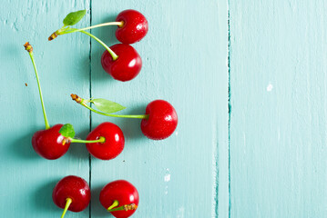 sour cherry fruits on old blue wooden table background