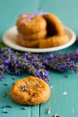 stack of lavender cookies on enamel plate, aged blue wooden table