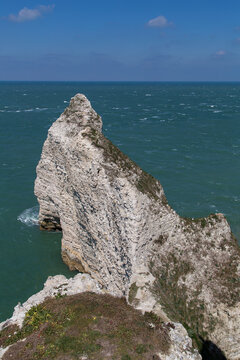 Porte d'Amont, chalk arched cliff in Etretat, Normandy, France. Vertical