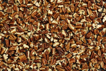 Texture of crushed pecan nuts. Directly Above.