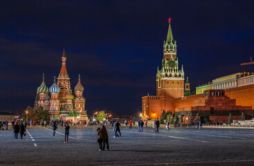Night view of Kremlin, Saint Basil's Cathedral and Lenin Mausoleum on Red Square with people walking in Moscow, Russia